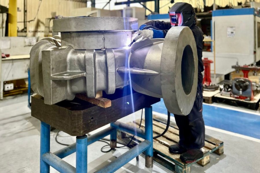 Machining company operator in Bilbao welding on an industrial valve body with ISO 3834-2 certification