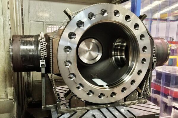 Valve body fixed in machining center; finished housings and gasket face with GD&T tolerances and verified roughness Ra.