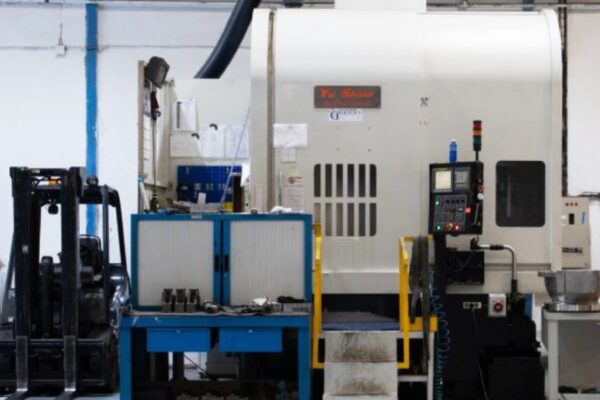 CNC machining center and tool preparation area in plant of ASIMER Group.