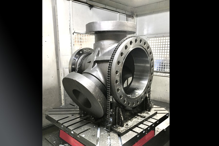 CNC finishing of a switch plug body with inclined fixturing: flanges and RTJ ready for flatness and true-position verification.
