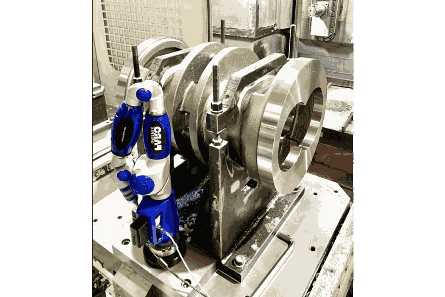 Brazo de medición FARO verificando una carcasa mecanizada de bomba industrial sobre la mesa de trabajo, control dimensional integrado en el proceso de mecanizado para reducir errores de medición en Asimer Group.